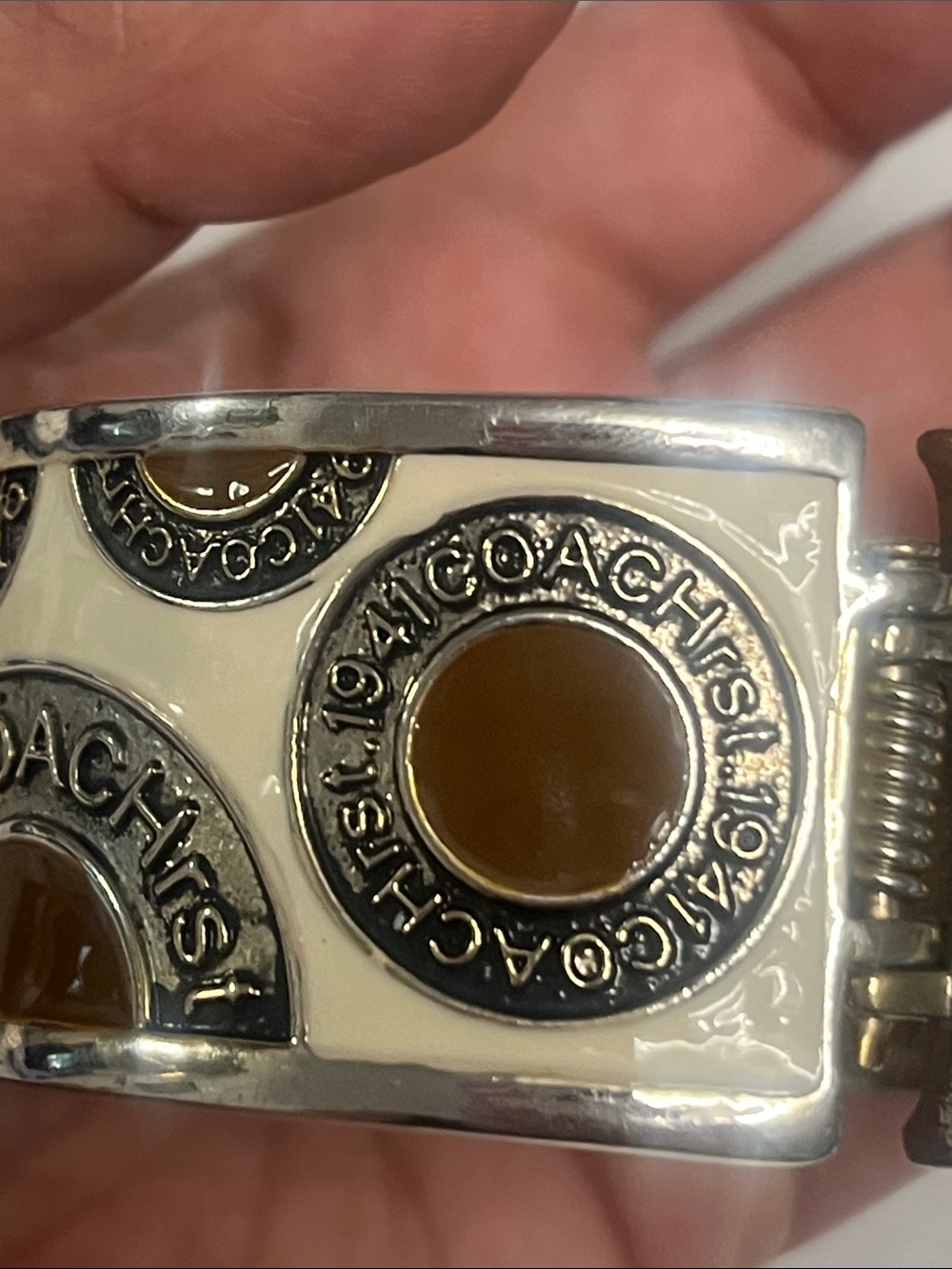 Cream colored coach bracelet
